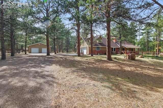 exterior space with a garage and an outdoor structure