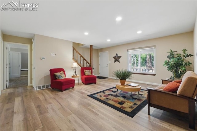 living room with stairs, recessed lighting, visible vents, and light wood-type flooring