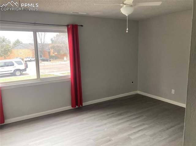 1708 Sawyer Way Unit 178, Colorado Springs, CO 80915 - empty room with baseboards, a textured ceiling, ceiling fan, and wood finished floors