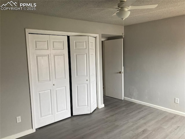 1708 Sawyer Way Unit 178, Colorado Springs, CO 80915 - unfurnished bedroom featuring ceiling fan, a textured ceiling, wood finished floors, baseboards, and a closet