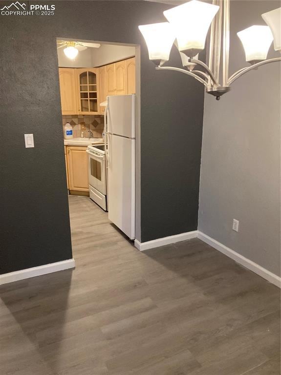 1708 Sawyer Way Unit 178, Colorado Springs, CO 80915 - kitchen with light wood-style floors, light brown cabinets, baseboards, and white appliances