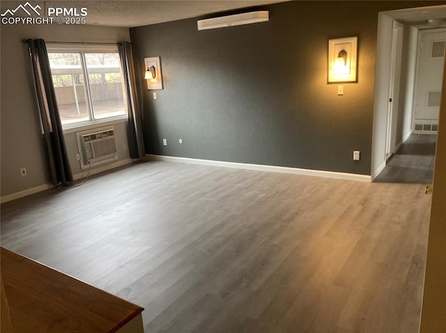 1708 Sawyer Way Unit 178, Colorado Springs, CO 80915 - spare room with baseboards, visible vents, wood finished floors, and cooling unit