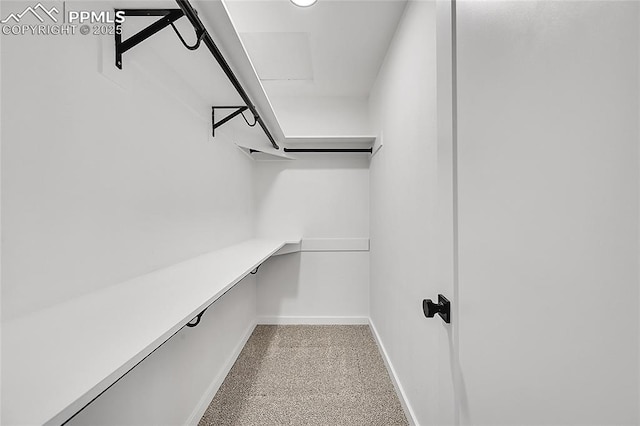 spacious closet featuring built in study area