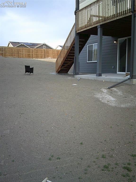 view of yard featuring stairway and a deck
