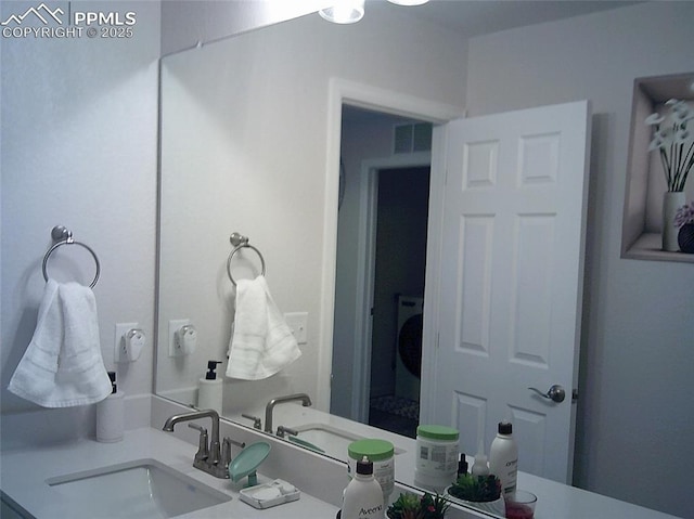bathroom featuring visible vents and a sink