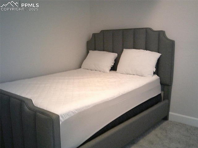 bedroom featuring baseboards and carpet floors