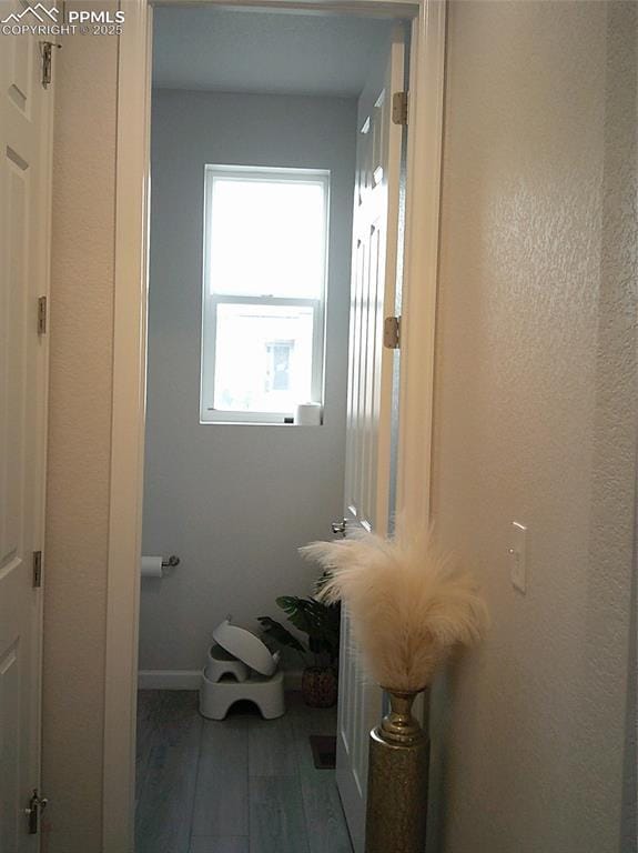 bathroom with wood finished floors and baseboards