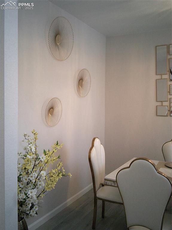 dining space with wood finished floors and baseboards
