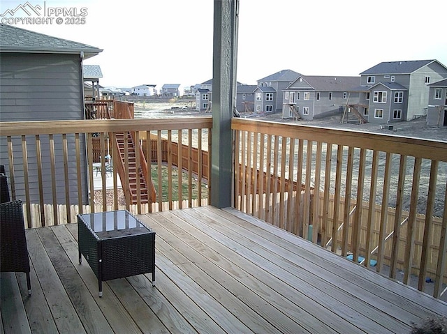 wooden deck featuring a residential view and stairs