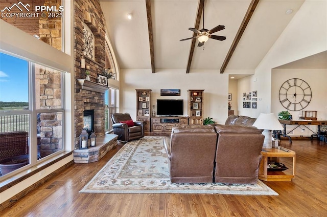 4908 Silver Nell Dr, Colorado Springs, CO 80908 - living room featuring a ceiling fan, high vaulted ceiling, a stone fireplace, and wood finished floors