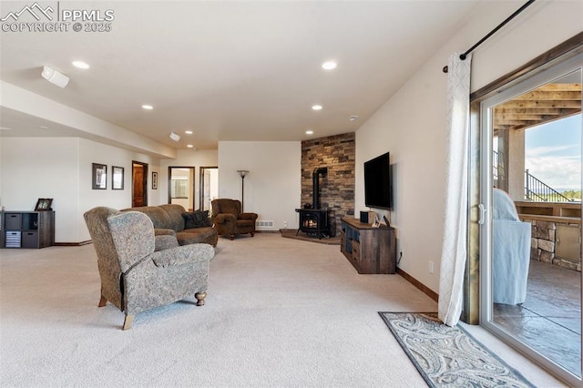 4908 Silver Nell Dr, Colorado Springs, CO 80908 - carpeted living room featuring recessed lighting, baseboards, visible vents, and a wood stove