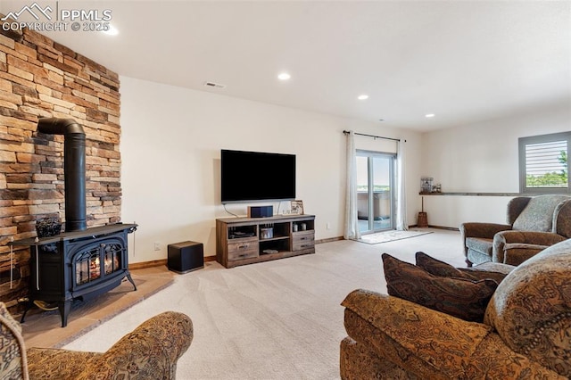 4908 Silver Nell Dr, Colorado Springs, CO 80908 - carpeted living area with visible vents, a wood stove, baseboards, and recessed lighting