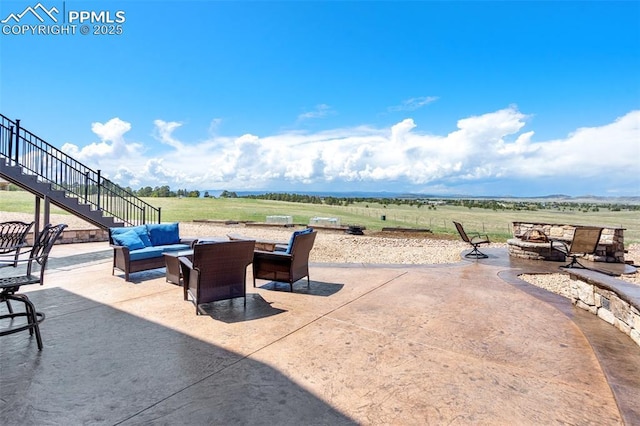 4908 Silver Nell Dr, Colorado Springs, CO 80908 - view of patio featuring stairway, a rural view, and an outdoor living space with a fire pit