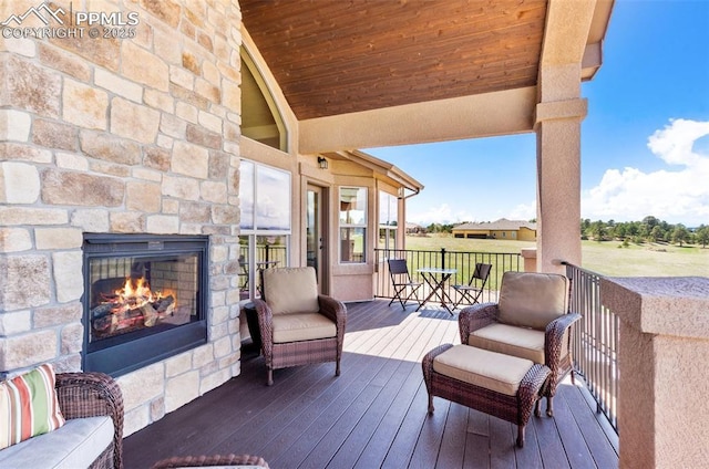 4908 Silver Nell Dr, Colorado Springs, CO 80908 - deck featuring an outdoor stone fireplace