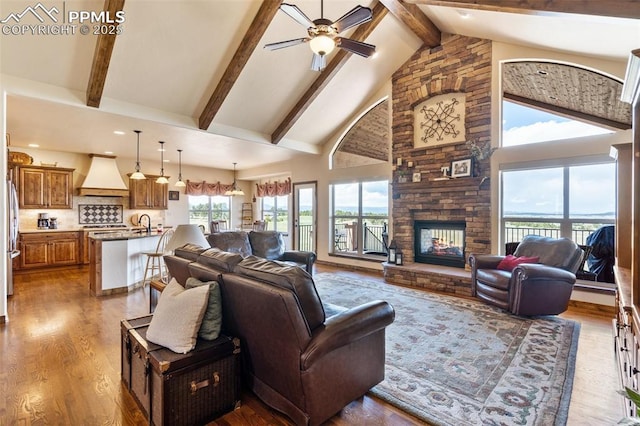 4908 Silver Nell Dr, Colorado Springs, CO 80908 - living room featuring high vaulted ceiling, ceiling fan, a fireplace, and dark wood-style floors