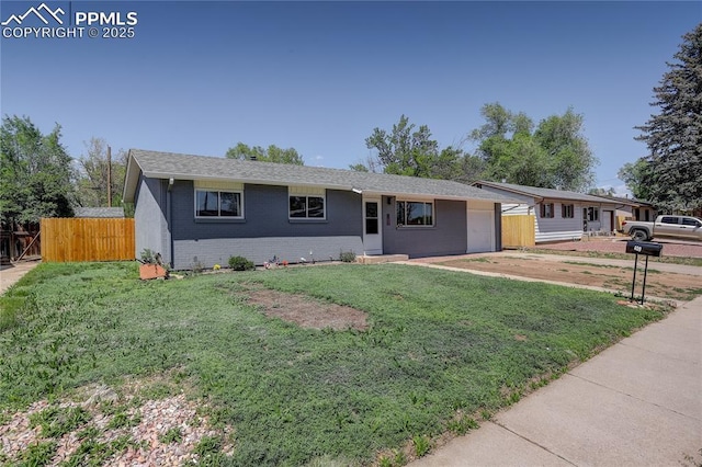 409 Columbine St, Fountain, CO 80817 - ranch-style house featuring a garage, driveway, brick siding, and a shingled roof