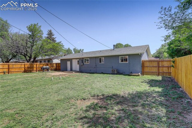 409 Columbine St, Fountain, CO 80817 - back of house with stucco siding and central AC unit