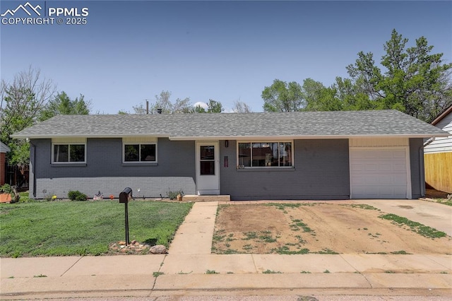 409 Columbine St, Fountain, CO 80817 - single story home with driveway, an attached garage, brick siding, and a shingled roof