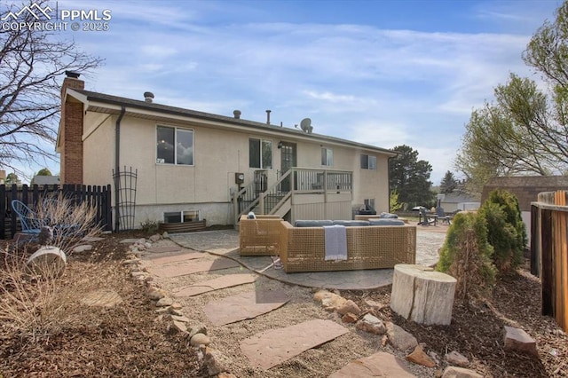 5064 Artistic Cir, Colorado Springs, CO 80917 - back of property with a patio, fence, stucco siding, and a chimney