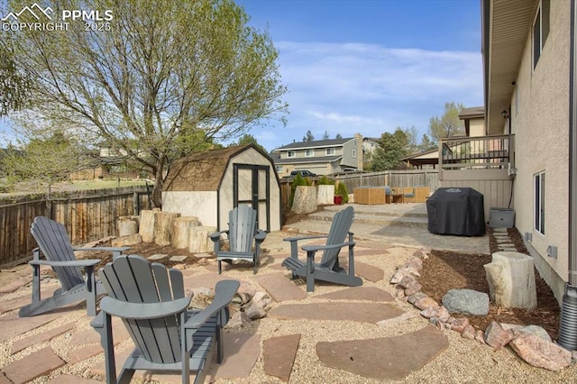 5064 Artistic Cir, Colorado Springs, CO 80917 - view of patio / terrace with a fenced backyard, a storage unit, an outdoor structure, and an outdoor fire pit