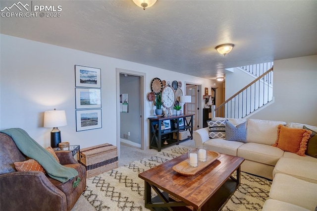 carpeted living area featuring stairway and baseboards
