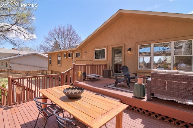 wooden deck featuring fence, an outdoor hangout area, and outdoor dining space