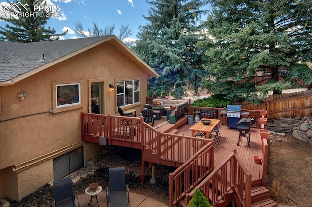 wooden deck featuring an outdoor living space, grilling area, fence, and stairs