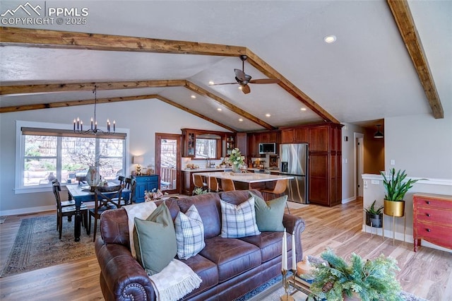 living room featuring ceiling fan with notable chandelier, lofted ceiling with beams, light wood-style flooring, baseboards, and recessed lighting