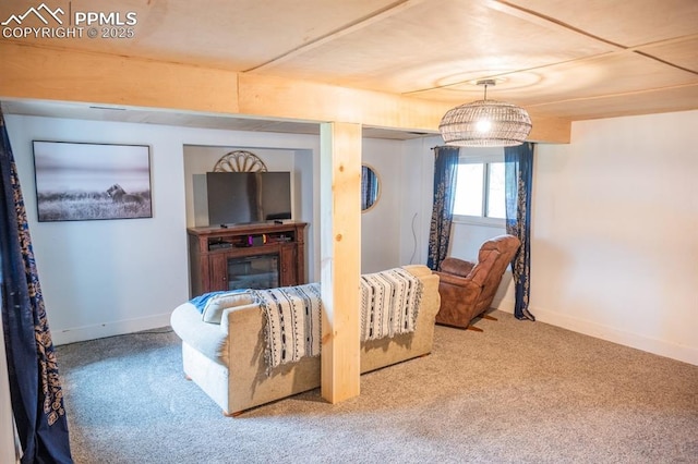 carpeted living area featuring baseboards