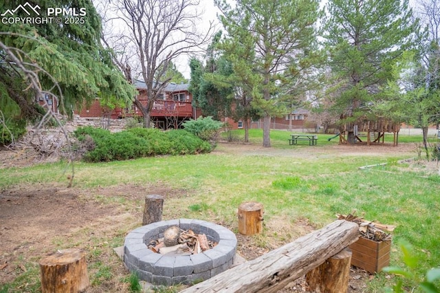 view of yard featuring an outdoor fire pit