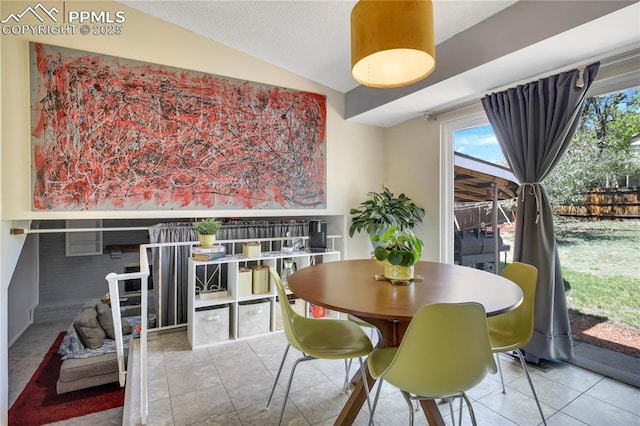 4230 Hollow Rd, Colorado Springs, CO 80917 - dining area featuring tile patterned flooring and lofted ceiling