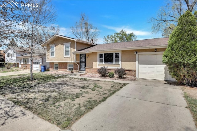 4230 Hollow Rd, Colorado Springs, CO 80917 - split level home featuring stucco siding, brick siding, driveway, and a garage