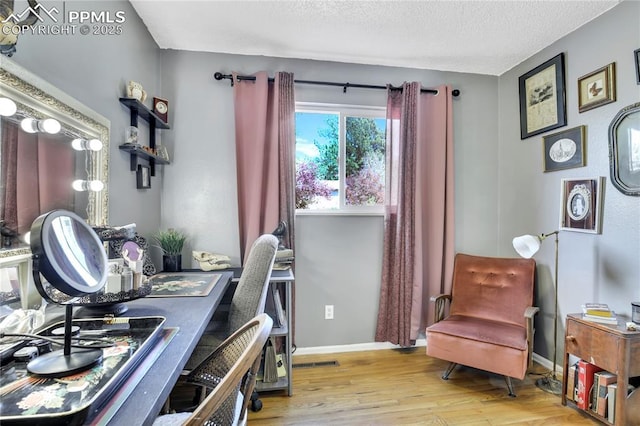 4230 Hollow Rd, Colorado Springs, CO 80917 - office featuring baseboards, a textured ceiling, wood finished floors, and visible vents
