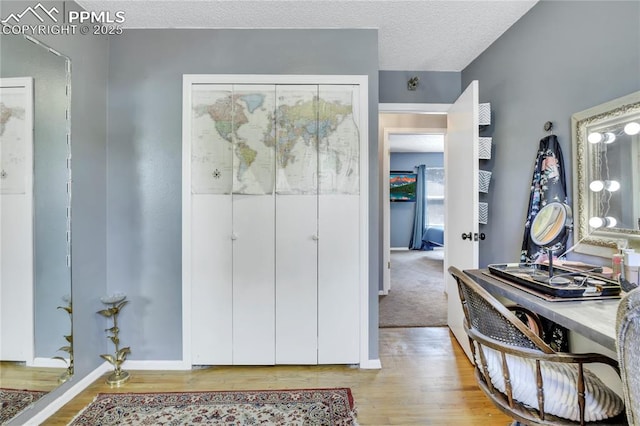 4230 Hollow Rd, Colorado Springs, CO 80917 - foyer with baseboards, light wood finished floors, and a textured ceiling