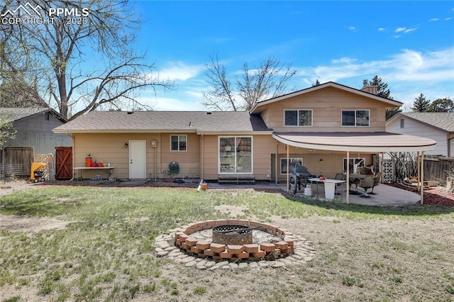 4230 Hollow Rd, Colorado Springs, CO 80917 - rear view of house featuring fence, an outdoor fire pit, a yard, a patio, and a shingled roof