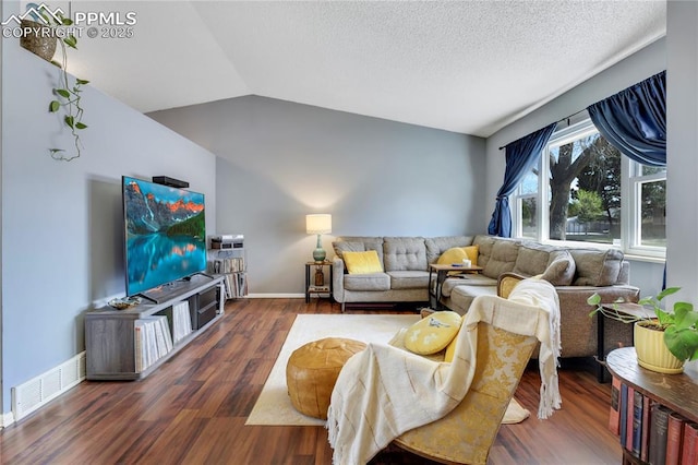 4230 Hollow Rd, Colorado Springs, CO 80917 - living area with visible vents, wood finished floors, baseboards, a textured ceiling, and vaulted ceiling