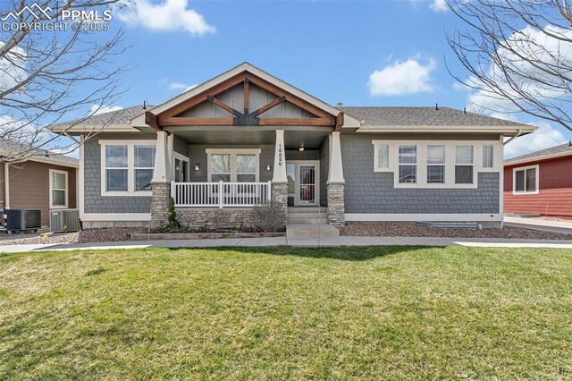 16850 Buffalo Valley Path, Monument, CO 81032 - craftsman-style home with a porch, a front lawn, central AC, and roof with shingles