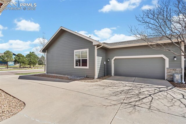 16850 Buffalo Valley Path, Monument, CO 81032 - view of side of home featuring a garage and concrete driveway
