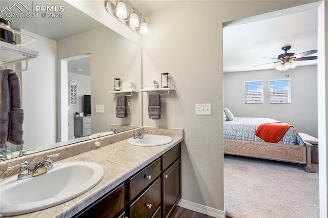 ensuite bathroom featuring ensuite bath, a ceiling fan, a sink, and double vanity