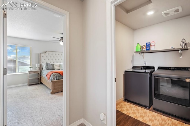 laundry area with washing machine and clothes dryer, a ceiling fan, laundry area, baseboards, and visible vents