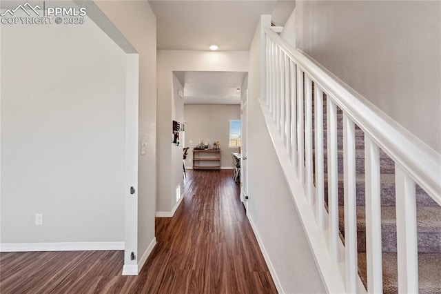 hall featuring recessed lighting, baseboards, dark wood-style floors, and stairway