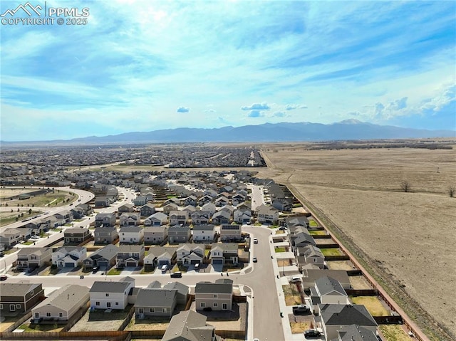 birds eye view of property with a mountain view and a residential view