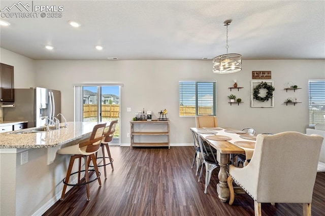 dining space featuring recessed lighting, a healthy amount of sunlight, baseboards, and dark wood-style flooring