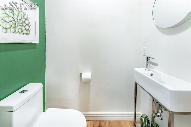 413 E Fontanero St, Colorado Springs, CO 80907 - bathroom featuring baseboards, wood finished floors, and toilet