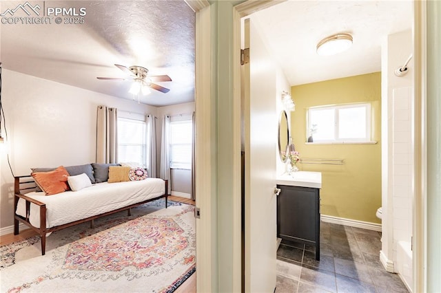 413 E Fontanero St, Colorado Springs, CO 80907 - bedroom featuring baseboards, multiple windows, and ensuite bath