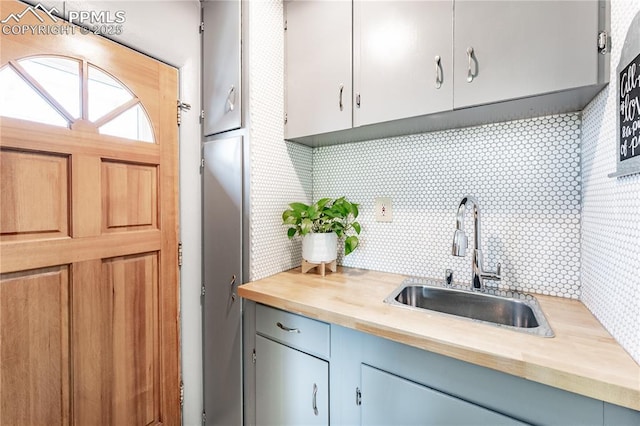 413 E Fontanero St, Colorado Springs, CO 80907 - kitchen with a sink, decorative backsplash, and wood counters