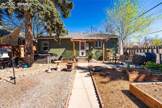413 E Fontanero St, Colorado Springs, CO 80907 - rear view of house with stucco siding, a garden, and fence