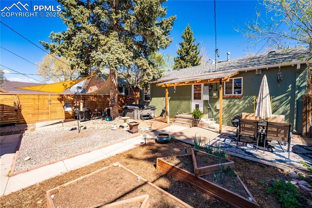 413 E Fontanero St, Colorado Springs, CO 80907 - rear view of property featuring a patio, a hot tub, stucco siding, and a garden