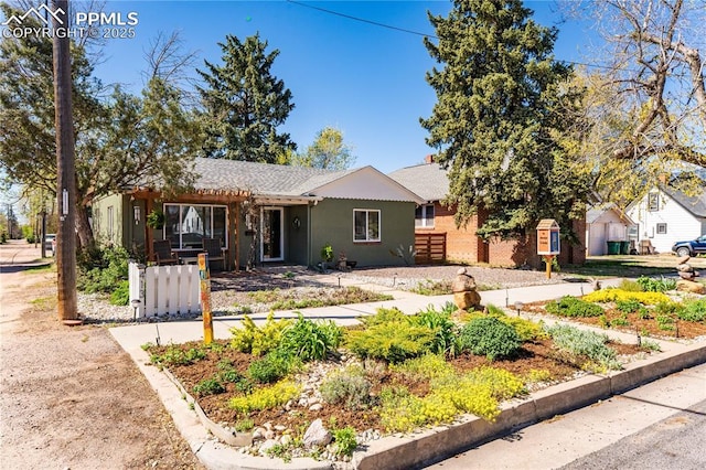 413 E Fontanero St, Colorado Springs, CO 80907 - view of front of property with fence, a shingled roof, and stucco siding