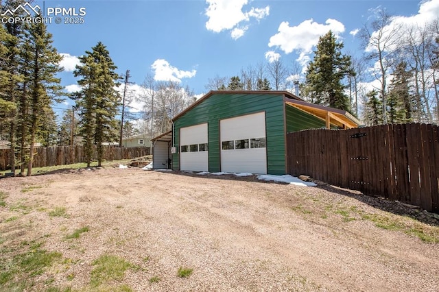 555 Elfin Glen Dr, Divide, CO 80814 - view of home's exterior with a garage, fence, an outbuilding, and driveway